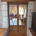 Porte double en chêne et faux linteau