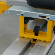 Support DeWALT DE7024 correctement positionné et serré sur le rail du piétement pour préparer le perçage du trou de fixation.