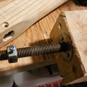 Détail de la fixation de la poignée à la tige filetée.