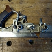 jauge de profondeur sur l'avant et l'arrière, vis de serrage au milieu, "éperon" sous la jauge avant