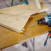 Le triangle coulisse contre le guide est est percé (il est en fait percé de l'autre côté, pas sur la face avec les dominos qui supporte l'étagère)