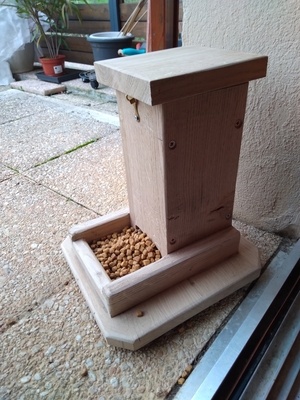 Distributeur croquettes pour chat en chêne.